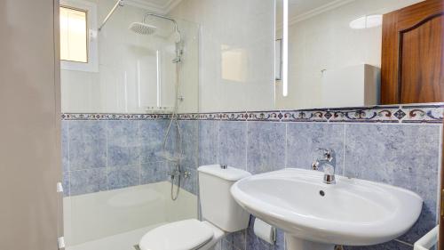 a bathroom with a sink and a toilet and a shower at Puerto Centro in Puerto del Rosario