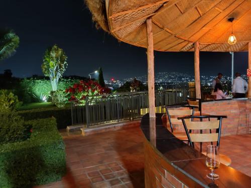 a bar with a view of the city at night at The Little Hill Boutique Hotel in Kigali