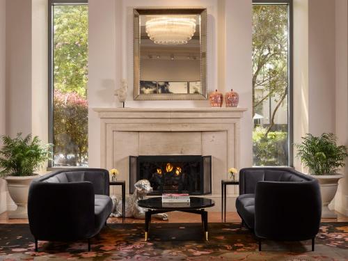 a living room with two chairs and a fireplace at InterContinental Buckhead Atlanta, an IHG Hotel in Atlanta