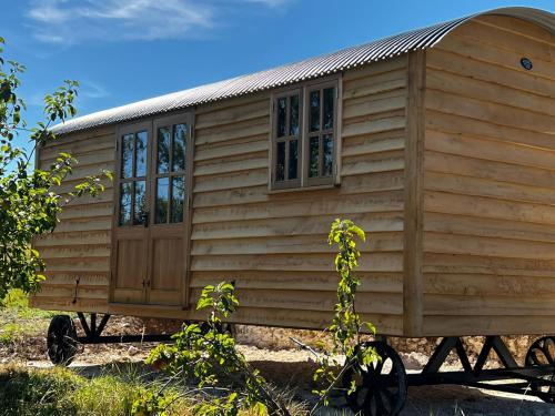 a wooden cabin on a wagon with a window at Robins Retreat - orchard with hot tub - see extras in Alfriston