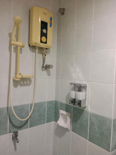 a shower in a bathroom with a shower at Yussal Homestay in Simpang Ampat Semanggol