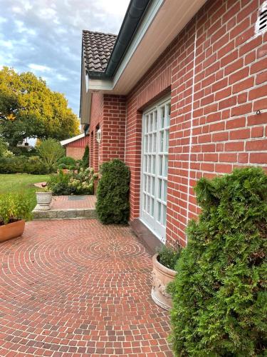 a brick house with a brick walkway in front of it at Garden View Apartment in Bad Segeberg