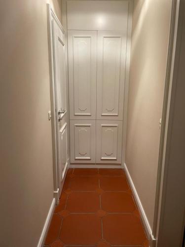 a hallway with a white door and a tile floor at Garden View Apartment in Bad Segeberg