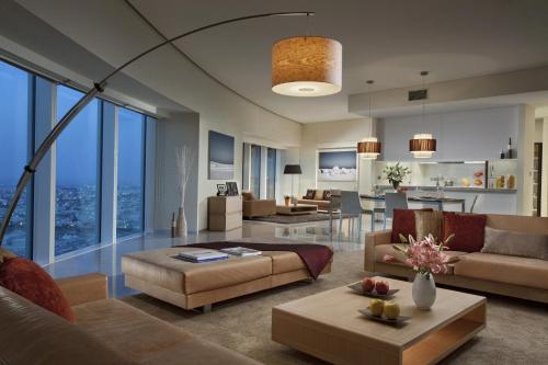 a living room with a couch and a table at Ascott Park Place Dubai in Dubai
