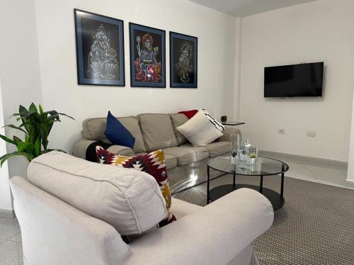 a living room with two couches and a table at MC Apartments in Puerto del Rosario