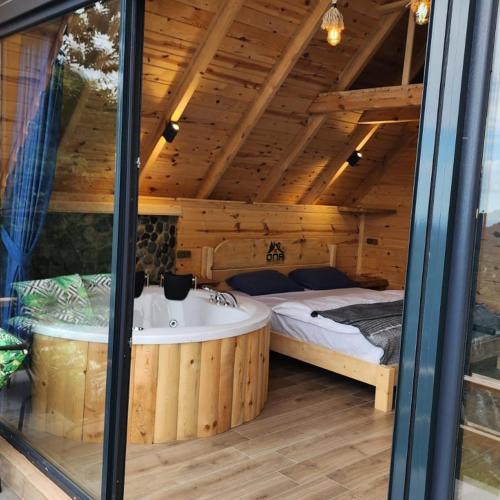 a bedroom with a tub and a bed in a room at ONASUITBUNGALOW in Rize
