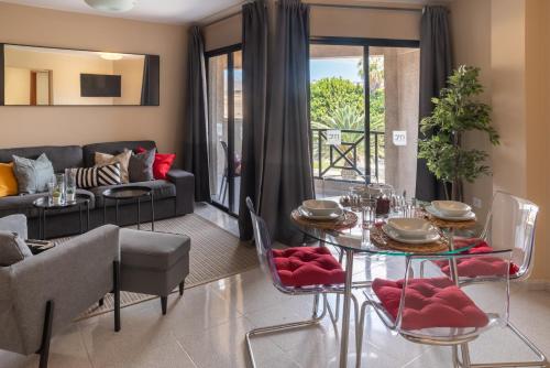 a living room with a table and a couch at MC Apartments in Puerto del Rosario