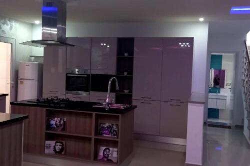 a kitchen with a sink and a counter top at Magnifique villa avec piscine sur l’île de Djerba pour vacances in Arkou