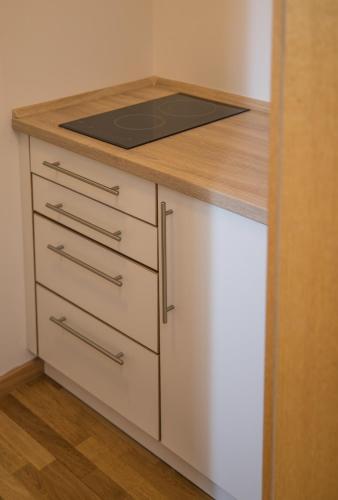 a kitchen island with a stove top on top of it at Hotel im Sonnental in Jachenau