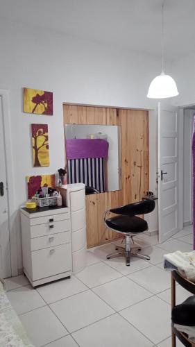 a room with a desk and a chair and a mirror at Hostel Rota do Vale in Blumenau