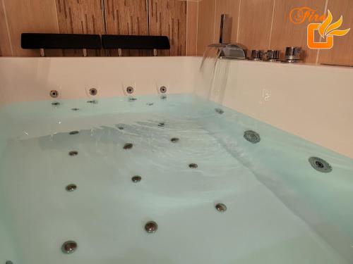 a jacuzzi tub in a room at My Cocoon in Court-Saint-Étienne