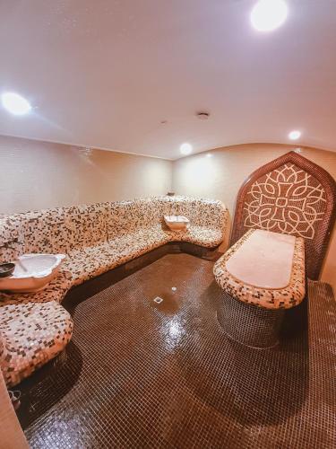 a room with a couch and two chairs and a table at Lusi Holiday, Смолянски езера in Smolyan