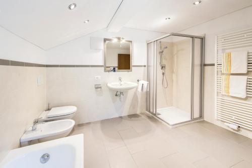 a bathroom with a toilet and a sink and a shower at Unterversanthof - Große Ferienwohnung für bis zu 6 Personen in Naturno