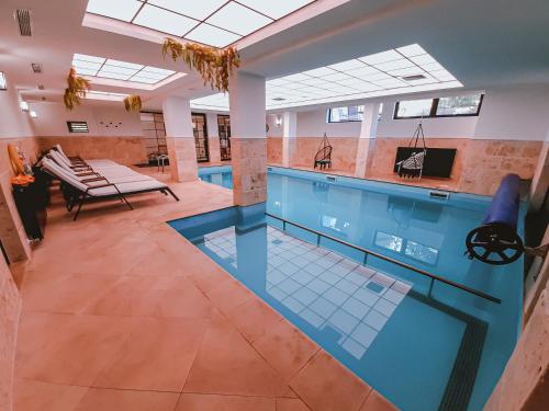 a pool in a building with a swimming pool at Lusi Holiday, Смолянски езера in Smolyan