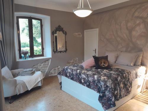 a bedroom with a bed and a chair in it at Ballerina Bianca bed & breakfast in Grottazzolina