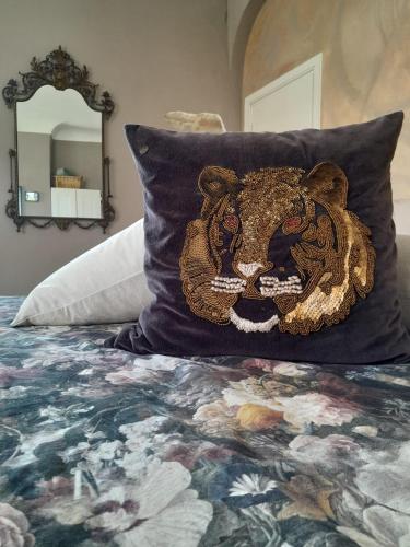 a pillow with a lion head on a bed at Ballerina Bianca bed & breakfast in Grottazzolina