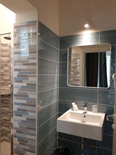 a bathroom with a sink and a mirror at Hotel Alabama by ALEhotels in Rimini