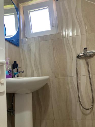 a bathroom with a sink and a window at Bujtina Arturi in Valbonë