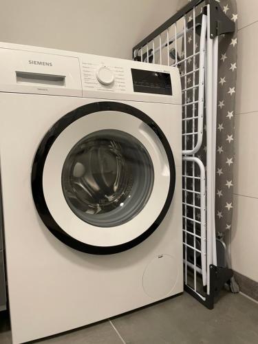 a white washing machine sitting in a laundry room at Moderne Wohnung nah am Cappenberger-See, 1-4 Gäste in Lünen