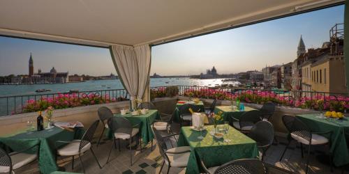 a restaurant with tables and chairs and a view of the water at Locanda Vivaldi in Venice