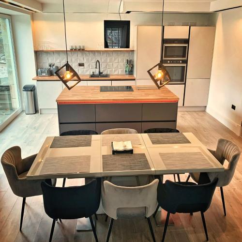 a kitchen with a dining room table and chairs at Laburnam Villa - Luxury 4 bedroom accommodation in the heart of Killin in Killin