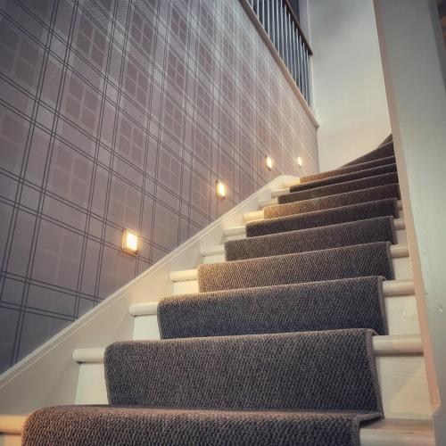 a set of stairs in a building at Laburnam Villa - Luxury 4 bedroom accommodation in the heart of Killin in Killin