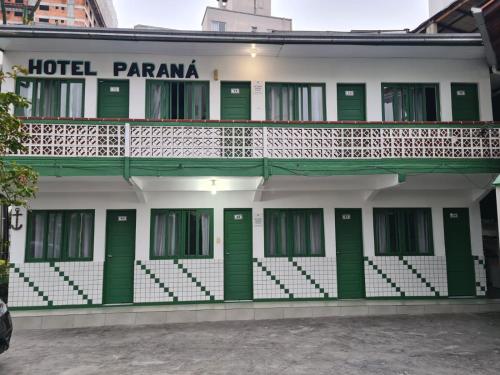a hotel pamana with green doors and a balcony at Hotel Paraná BC in Balneário Camboriú