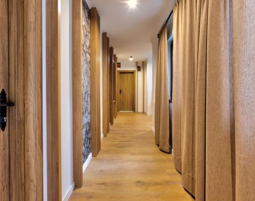 a hallway with wooden floors and wooden walls at Hotel Sinan Han in Mostar