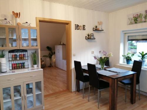 a kitchen and dining room with a table and chairs at Ferienwohnung altes Steinlager in Oderberg