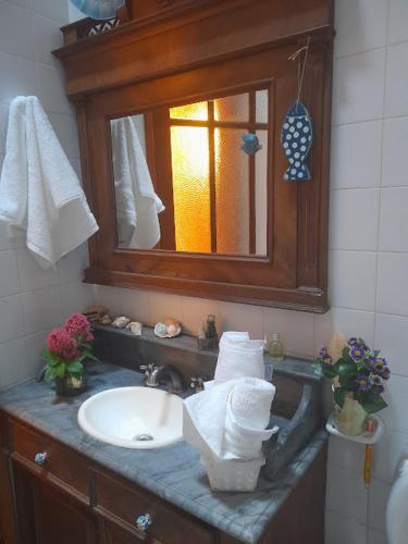 a bathroom with a sink and a mirror at Casona Leyría Boutique in Azul