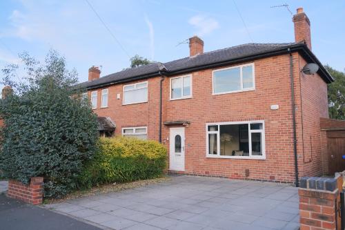 a brick house with a driveway in front of it at Bee Stays - Northway House in Warrington