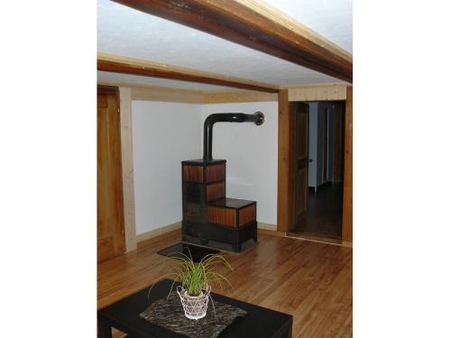 a floor lamp in a living room with a table at Apartment Lindi in Lütschental