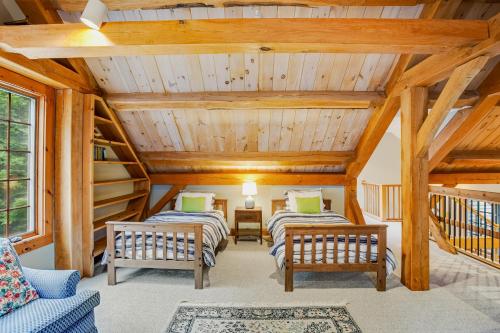 2 camas en una habitación con techos de madera en Glen Road Lodge en Peru