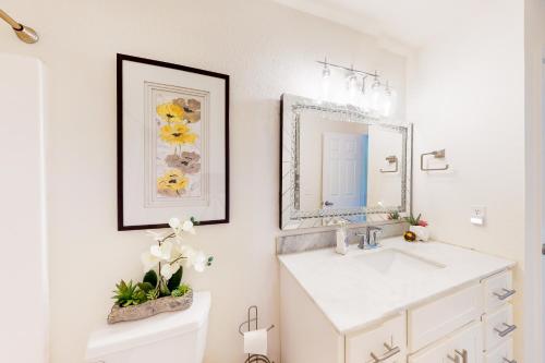 a bathroom with a sink and a mirror at A Little Lake Retreat in Branson