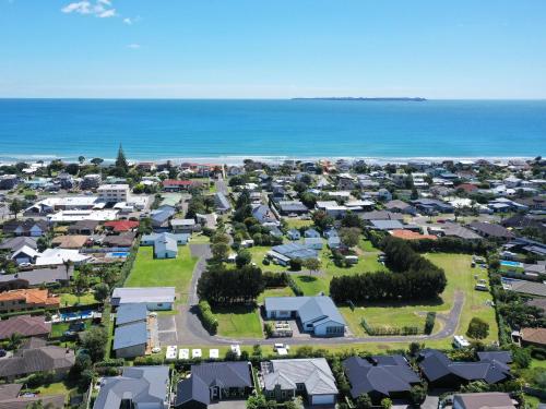 an aerial view of a suburb next to the ocean at Pacific Park Christian Holiday Camp in Papamoa