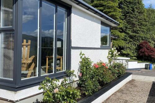 a house with a window with a chair in it at Foinaven House in Ullapool