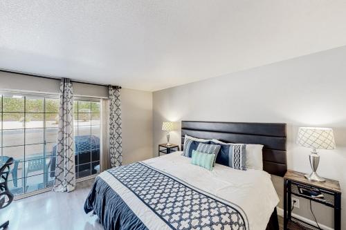 a bedroom with a bed and a balcony at Mesquite Country Club Condo D23 Permit# 1199 in Palm Springs