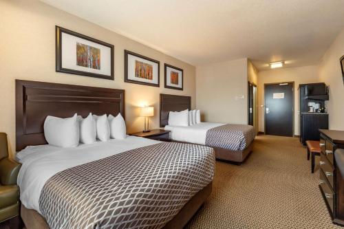 a hotel room with two beds and a television at Best Western Plus The Inn at St Albert in St. Albert