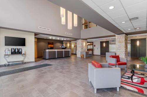 an office lobby with couches and a tv at Best Western Plus Eastgate Inn & Suites in Regina