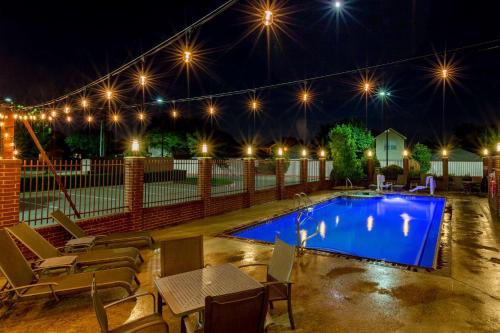 a swimming pool at night with lights above it at Best Western Plus Duncanville/Dallas in Duncanville