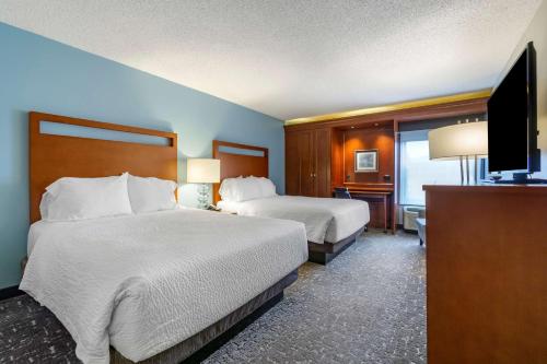 a hotel room with two beds and a flat screen tv at Best Western Plus Bellingham in Bellingham