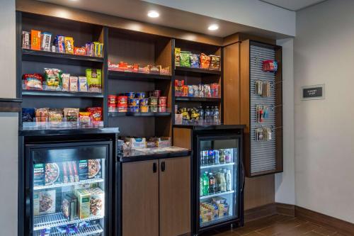 a room with two refrigerators and shelves of food at Best Western Plus Bellingham in Bellingham