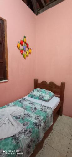 a bedroom with two beds in a pink wall at Pousada Labarca in Cachoeira
