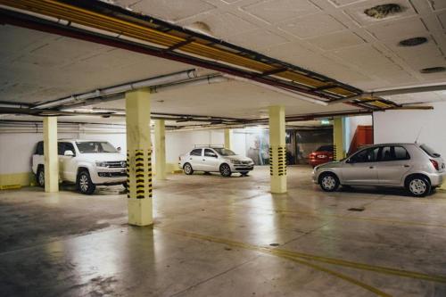 a parking garage with several cars parked in it at Posada de San Isidro in San Isidro