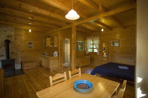 a wooden room with a table and a kitchen at Ranch Jelov Klanac in Rakovica
