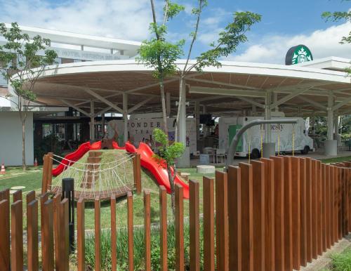 a playground in front of a building with a fence at Residencias Cityzen cerca del Aeropuerto in Echeverría