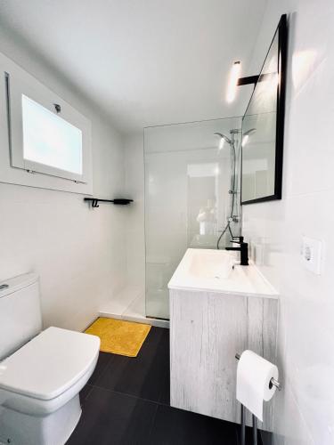 a white bathroom with a sink and a toilet at ZEN Apartment sea views in Tossa de Mar