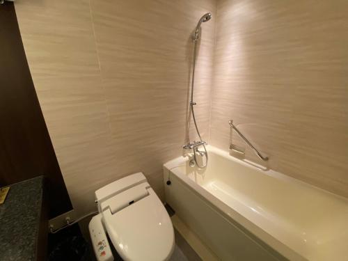 a bathroom with a white toilet and a shower at Nagoya Tokyu Hotel in Nagoya
