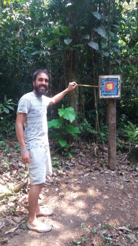 a man is standing next to a box at Cabañas eco lógicas mu'ü in Loreto Mocagua