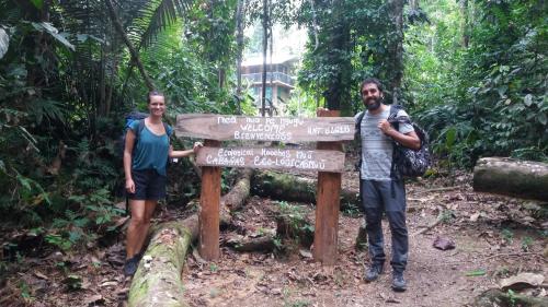 two people standing next to a sign in the forest at Cabañas eco lógicas mu'ü in Loreto Mocagua